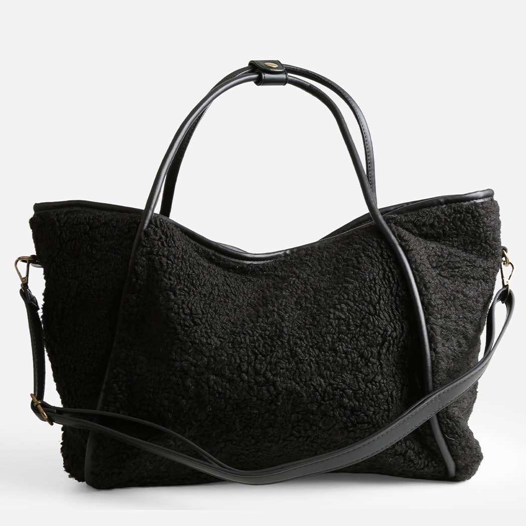 Black textured handbag with a shoulder strap on a white background