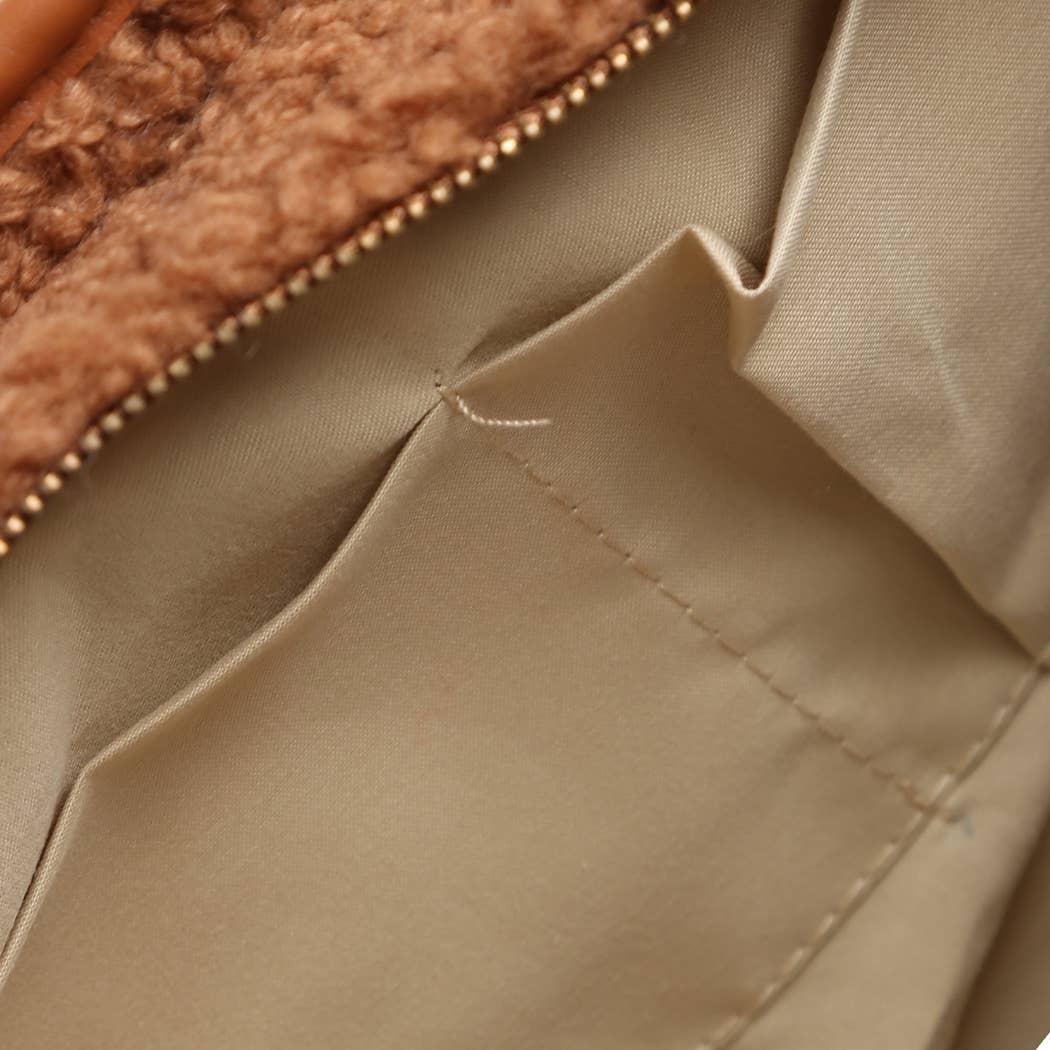 Close-up of beige fabric with a zipper in the background