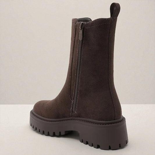 Brown boot with a zipper on a light gray background