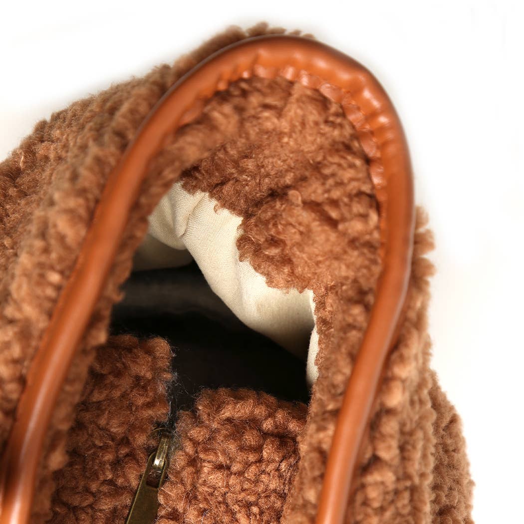 Close-up of a brown textured bag with a white interior