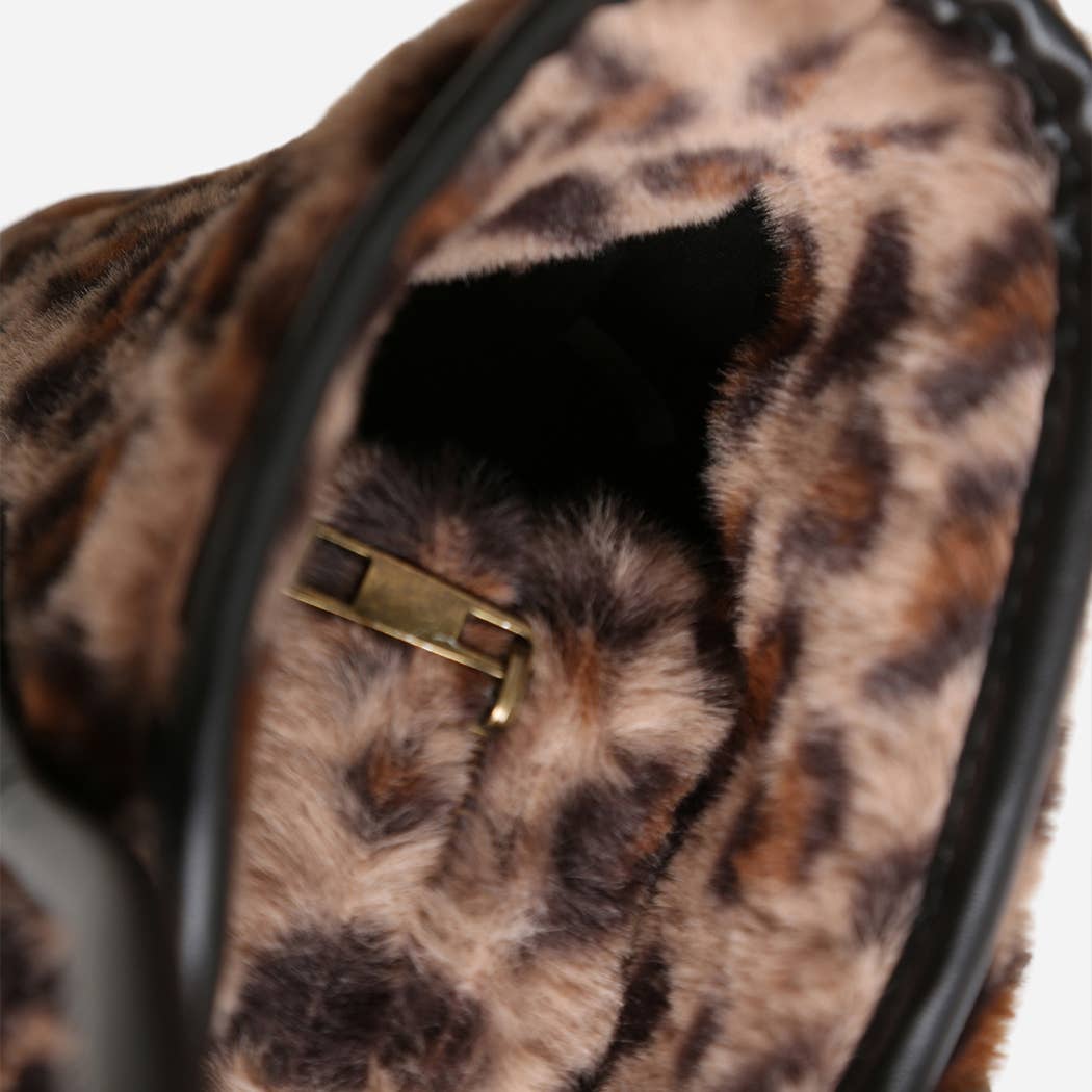 Close-up of a leopard print bag with a gold clasp on a white background
