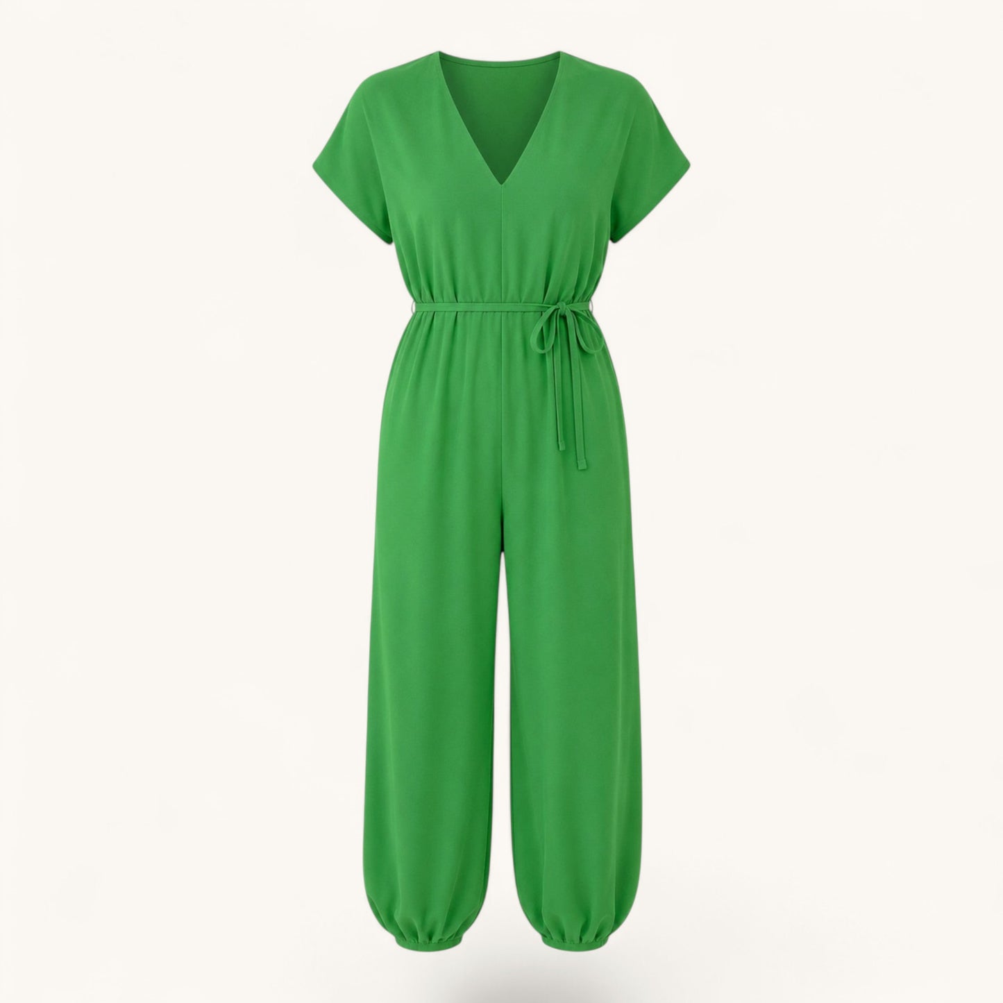 Feather & Sole green fluid jumpsuit with V-neck, short sleeves, and a tie-waist in lightweight polyester fabric.