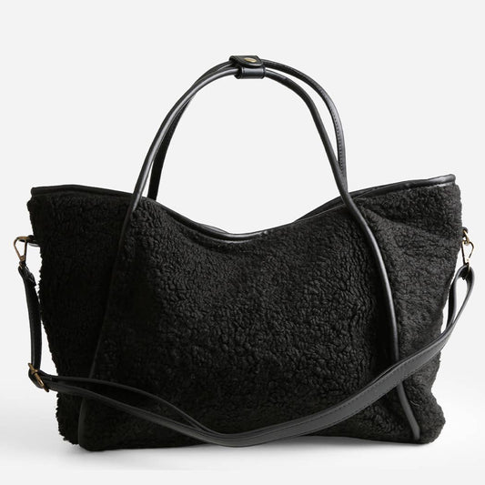Black textured handbag with a shoulder strap on a white background