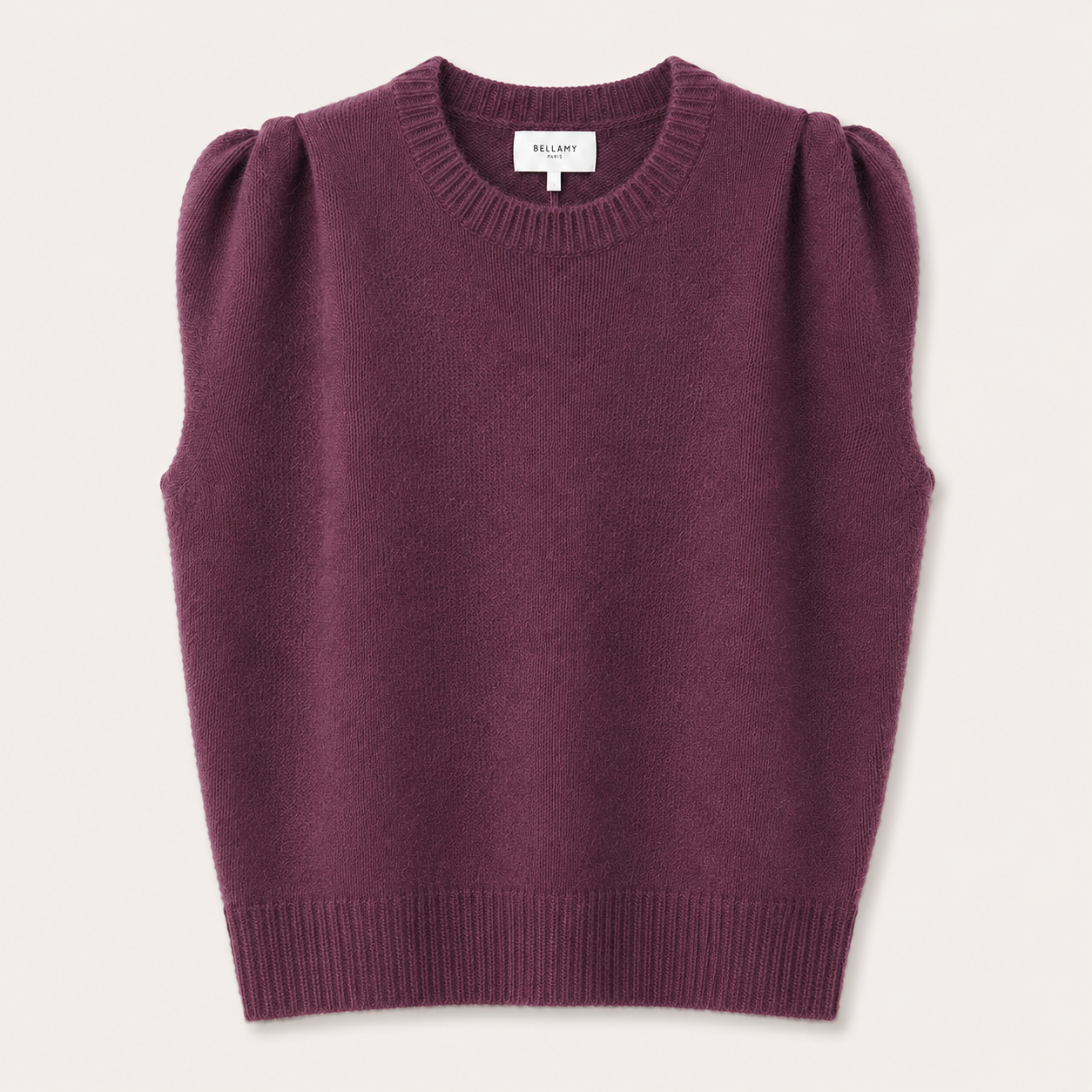 A sleeveless knit sweater vest in a deep plum purple color, featuring puffed shoulders, a crew neckline, and ribbed trim, shown flat against a light cream background. The brand name BILLABY is visible on the inner neck label.