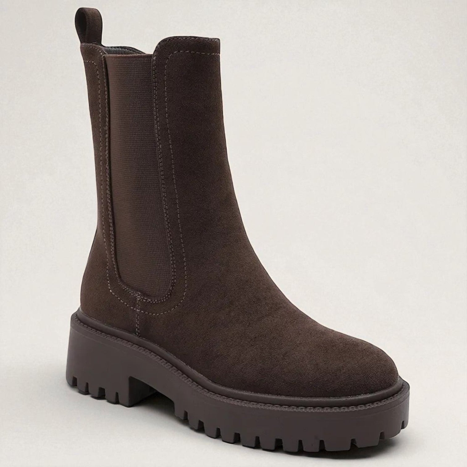 Brown boot on a light gray background
