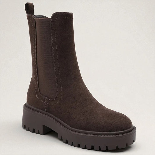 Brown boot on a light gray background
