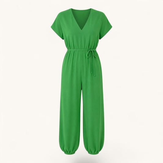 Feather & Sole green fluid jumpsuit with V-neck, short sleeves, and a tie-waist in lightweight polyester fabric.