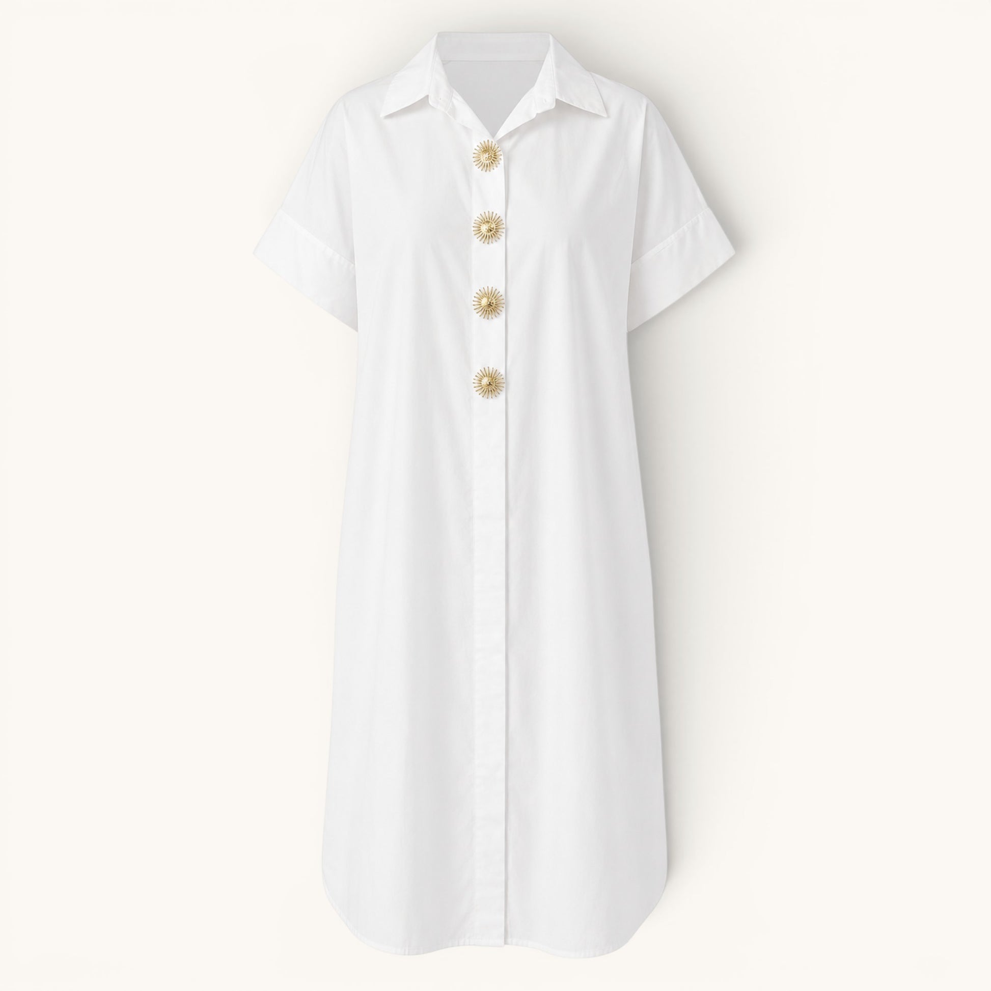 Feather & Sole white oversized cotton shirt dress with short sleeves and decorative gold sunburst buttons.