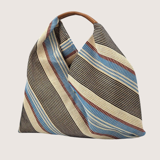 Feather & Sole blue, beige, and maroon striped woven shoulder bag with a brown leather handle.