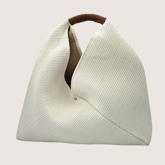 Feather & Sole beige woven shoulder bag with a brown leather handle and a slouchy silhouette.