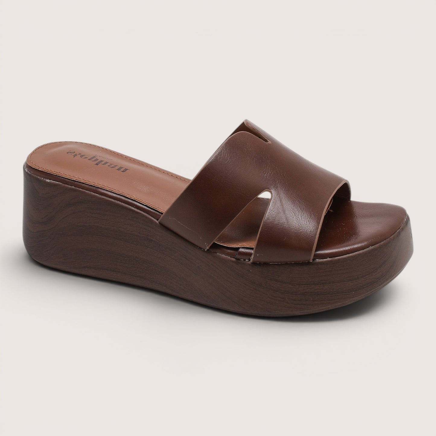 Feather & Sole brown faux leather flatform mule sandals with a criss-cross strap design and a wooden-effect sole.