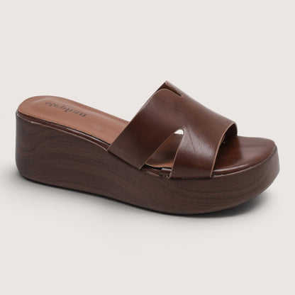Feather & Sole brown faux leather flatform mule sandals with a criss-cross strap design and a wooden-effect sole.