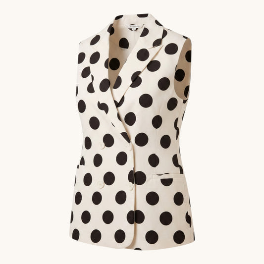 Feather & Sole sleeveless white polyester vest with large black polka dots, notched collar, and double-breasted buttons.