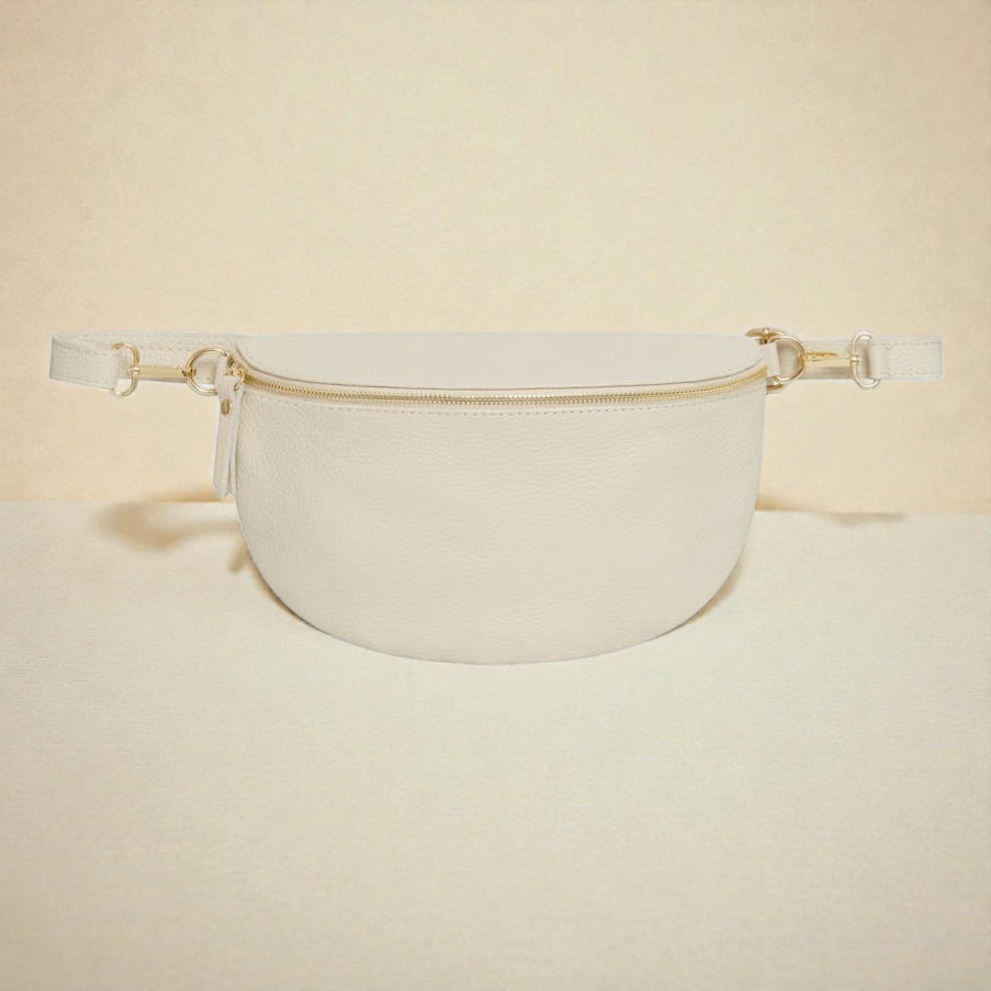 Feather & Sole Italian genuine leather crescent bum bag in cream with gold hardware and zipper closure. Includes interior zip pocket.